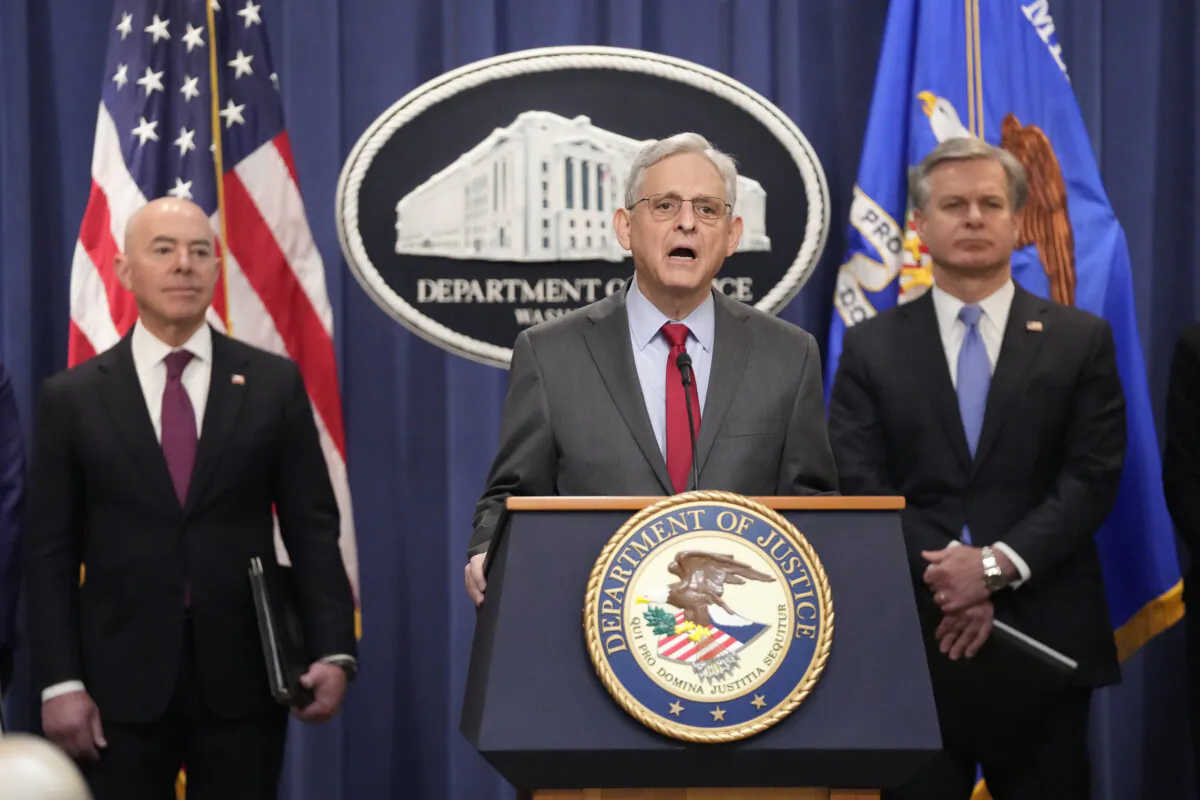 As Secretary of Homeland Security Alejandro Mayorkas (L), and FBI Director Christopher Wray (R), looks on Attorney General Merrick Garland (C) speaks with reporters during a news conference at the Department of Justice in Washington on Dec. 6, 2023. (Mark Schiefelbein/AP Photo)