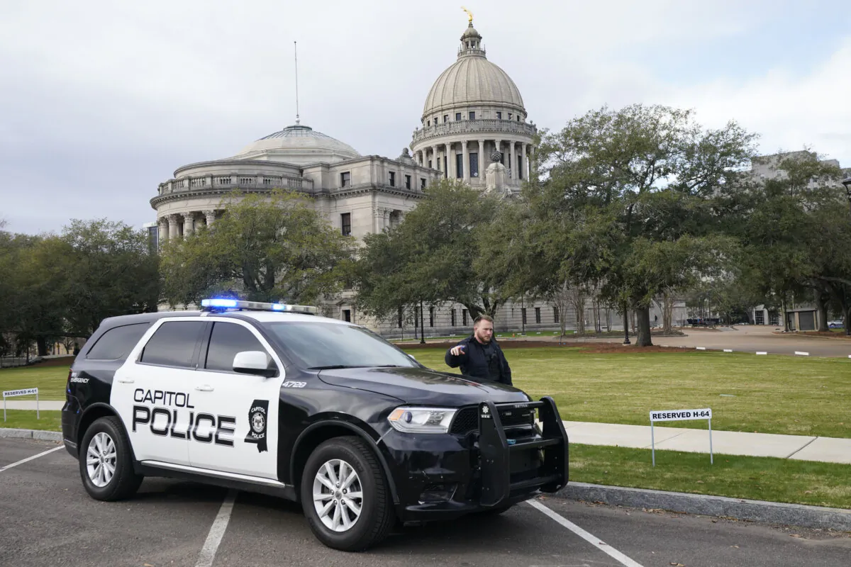 A Capitol Police officer warns passersby as police respond to a bomb threat at the Mississippi Capitol in Jackson on Jan. 3, 2024. (Rogelio V. Solis/AP Photo)