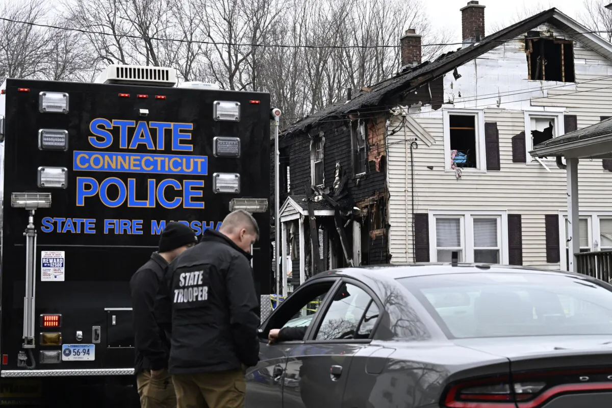State Police gather at the aftermath of a fire in two-family home in Somers, Conn., on Jan. 3, 2024. (Jessica Hill/AP Photo)