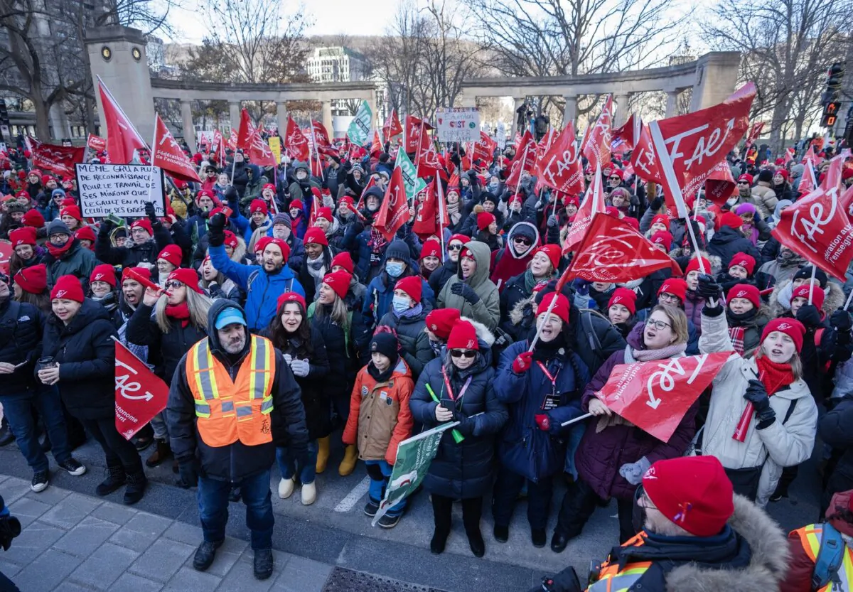 Striking teachers and their supporters hold a rally in front of Premier François Legault's office in Montreal on Dec. 22, 2023. (The Canadian Press/Ryan Remiorz)