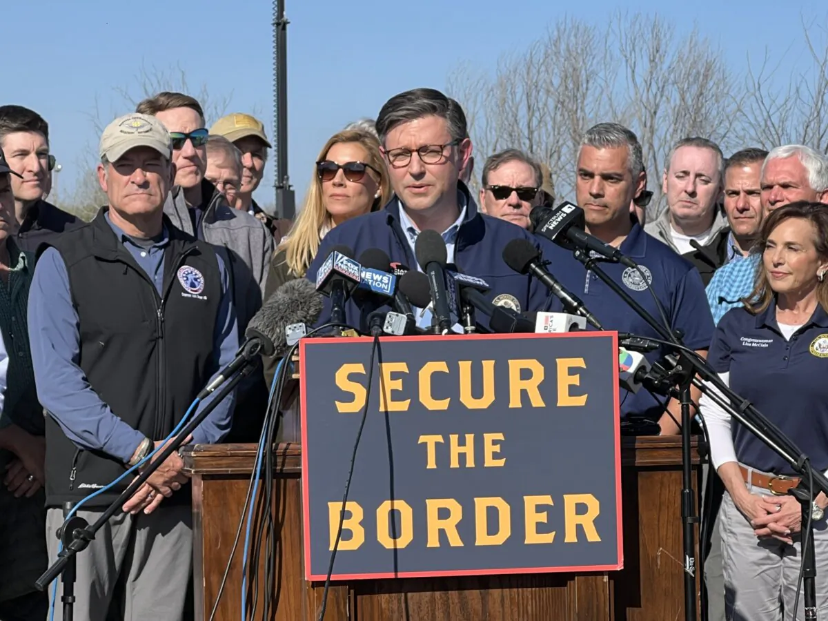 House Speaker Mike Johnson speaks while standing with Republican members of Congress in Eagle Pass, Texas, on Jan. 3, 2024. (Charlotte Cuthbertson/The Epoch Times)