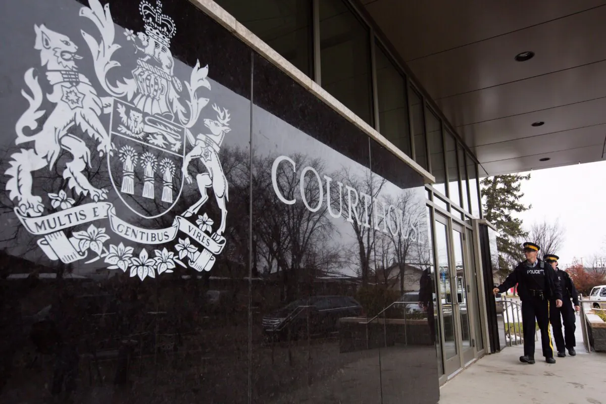 RCMP officers arrive to court in Meadow Lake, Sask., where a teen was undergoing trial related to the killing of four people in a school in Saskatchewan, on Oct. 28, 2016. (The Canadian Press/Amber Bracken)
