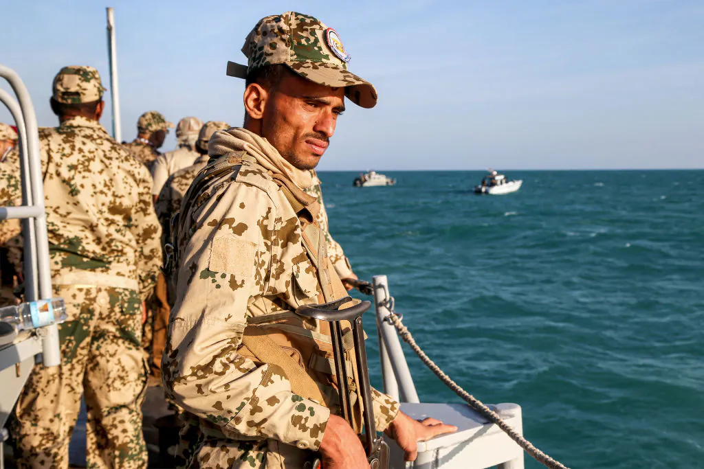 A Yemeni coastguard member loyal to the internationally-recognised government rides in a patrol boat in the Red Sea off of the government-held town of Mokha in the western Taiz province, close to the strategic Bab al-Mandab Strait, on Dec. 12, 2023. (Khaled Ziad/AFP via Getty Images)