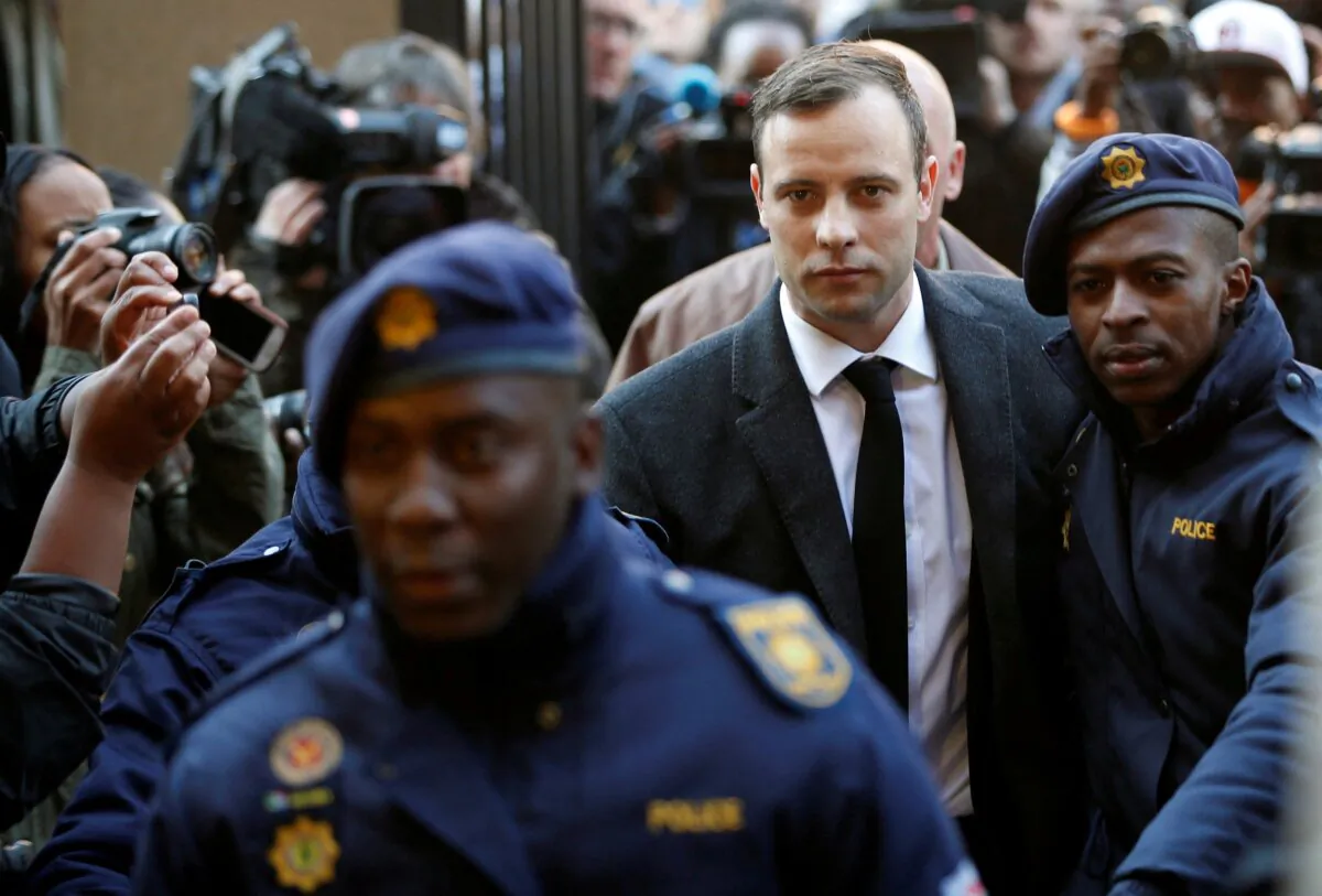 Olympic and Paralympic track star Oscar Pistorius is escorted by police officers as he arrives for his sentencing for the 2013 murder of his girlfriend Reeva Steenkamp at North Gauteng High Court in Pretoria, South Africa, on July 6, 2016. (Siphiwe Sibeko/Reuters)