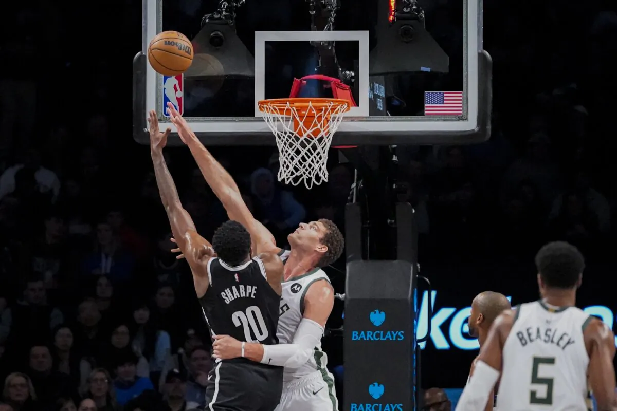 Brooklyn Nets center Day'Ron Sharpe (20) shoots over Milwaukee Bucks center Brook Lopez during the first half of an NBA basketball game in New York on Dec. 27, 2023. (Peter K. Afriyie/AP Photo)