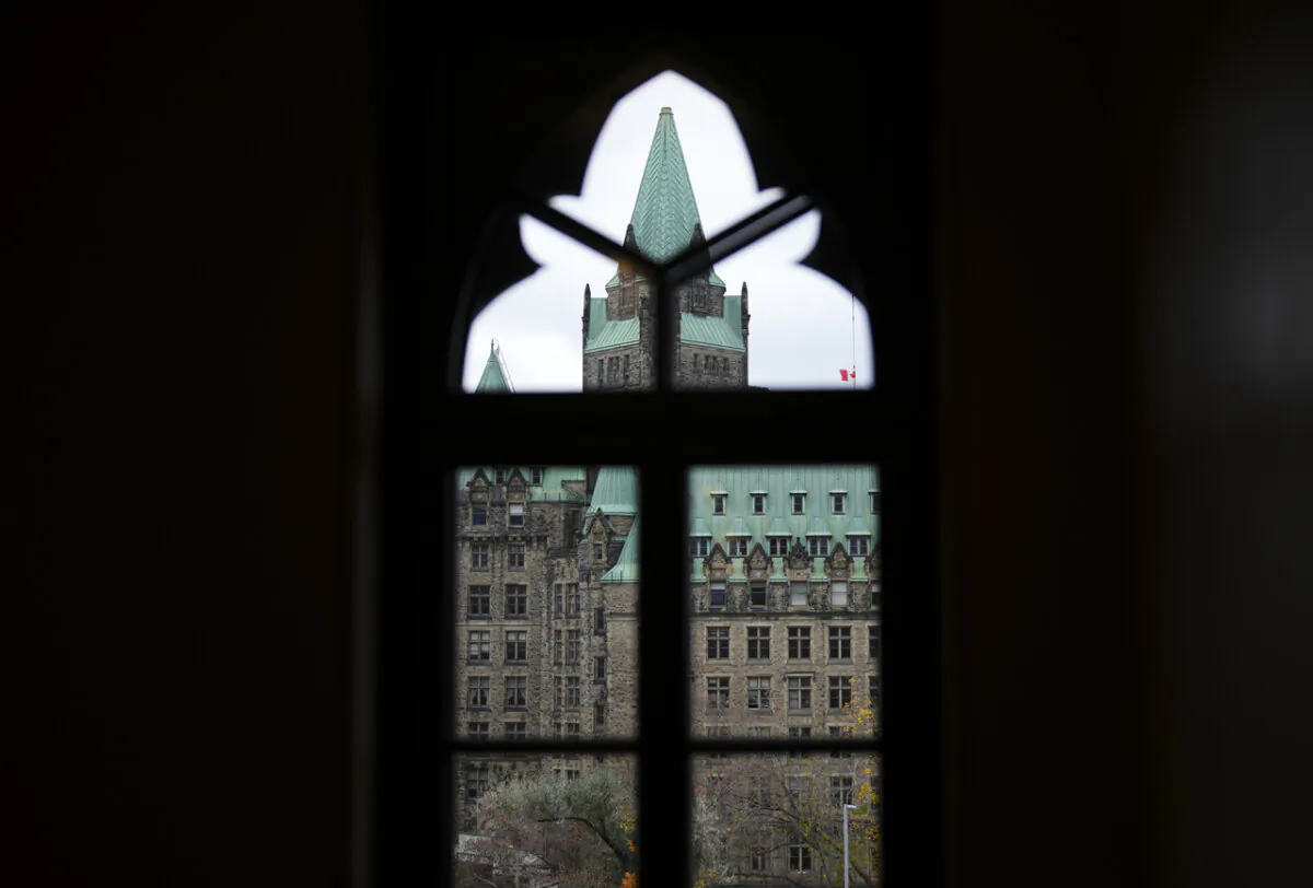 The Confederation Building is pictured through a window on Parliament Hill in Ottawa on Nov. 7, 2023. (The Canadian Press/Sean Kilpatrick)