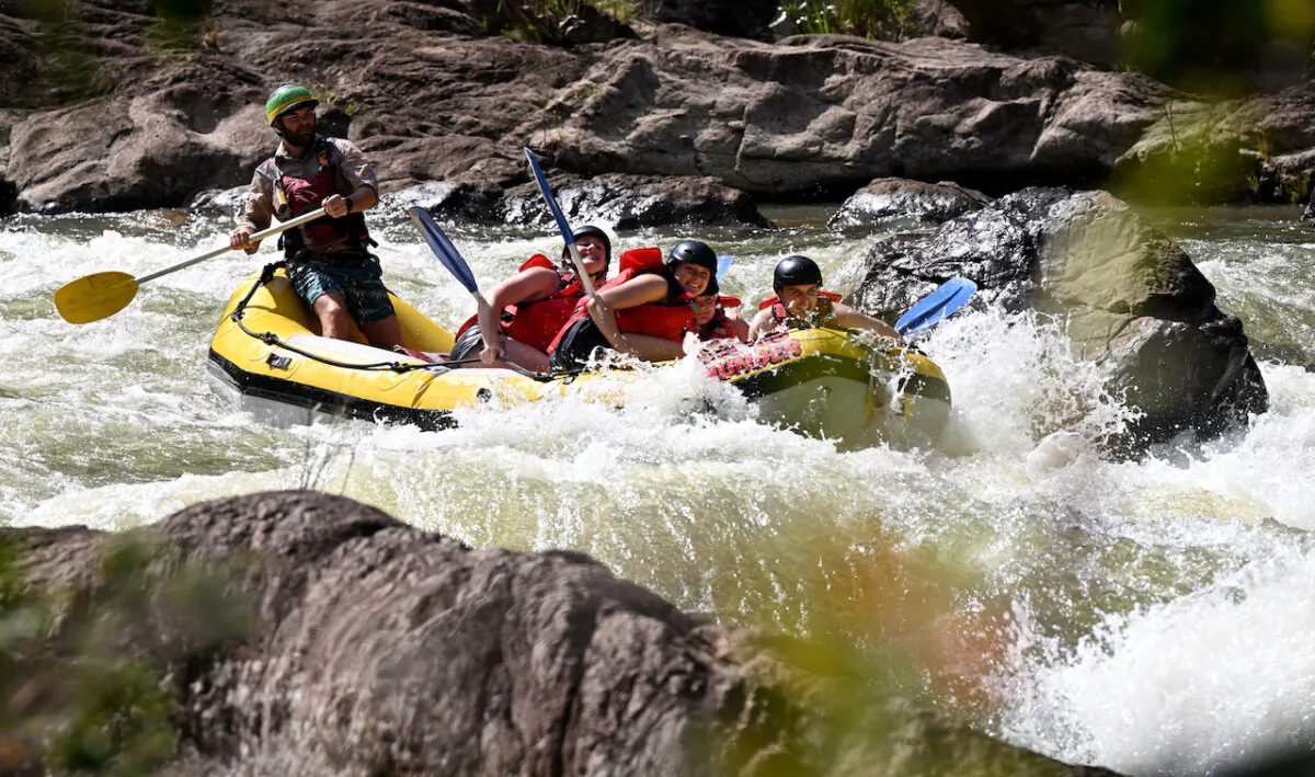 Tourists are seen white water rafting on the Tully River with river guides from Raging Thunder Adventures in the North Queensland town of Tully, on Jan. 4, 2024. (AAP Image/Darren England)