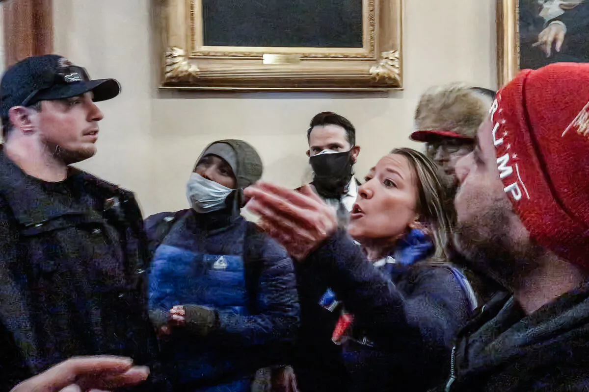 Moments before being fatally shot, Ashli Babbitt confronts three police offers for not stopping the vandalism outside the U.S. House. (Tayler Hansen/Screenshot via The Epoch Times)