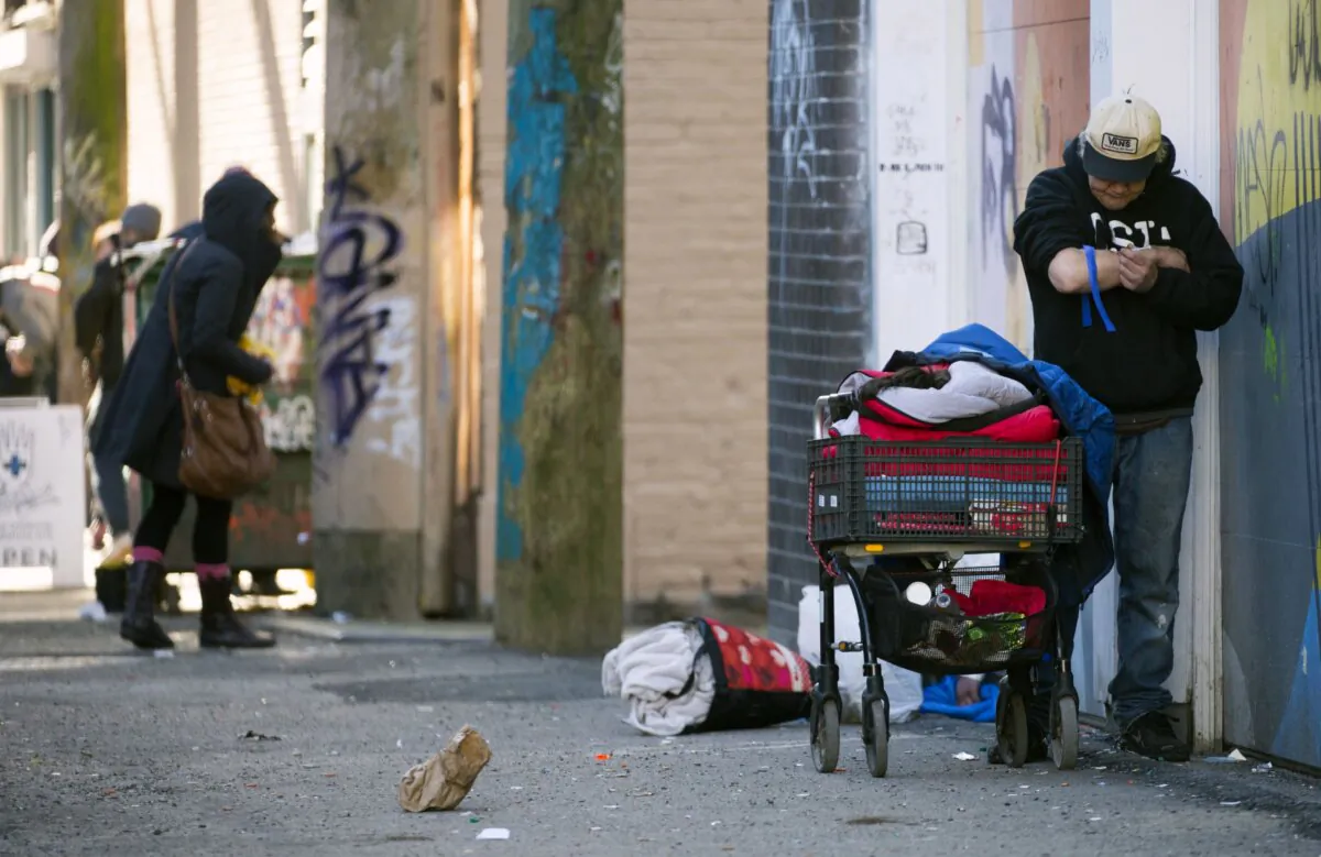 A man injects drugs on a street in Vancouver's Downtown Eastside on Feb. 6, 2019. (The Canadian Press/Jonathan Hayward)