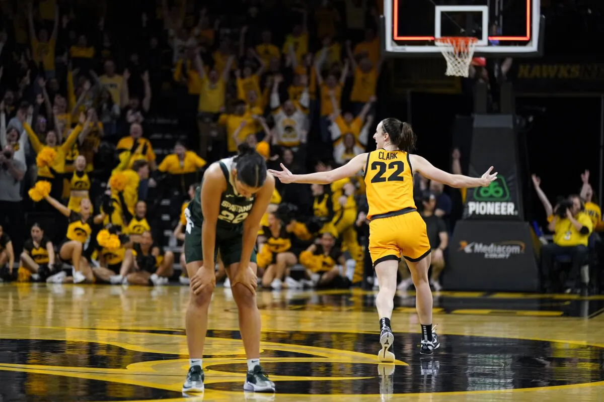Iowa guard Caitlin Clark (R) celebrates in front of Michigan State guard Moira Joiner (L) after her three-point basket at the end of an NCAA college basketball game in Iowa City, Iowa, on Jan. 2, 2024. (Charlie Neibergall/AP Photo)