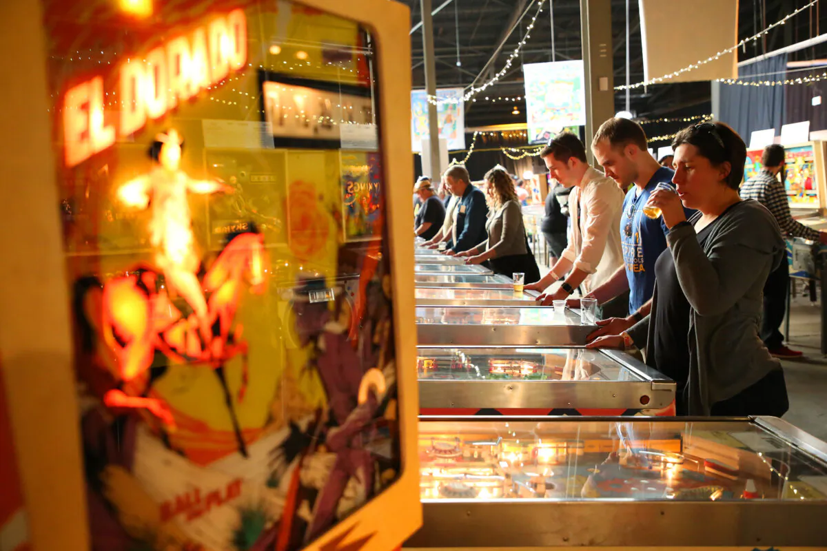 Guests sample beer and play pinball at the Pinball and Pints event at the Pacific Pinball Museum Annex on Feb. 12, 2017, in Berkeley, California. The guests were able to play over 400 pinball games while sampling beer as part of SF Beer Week. (Aric Crabb/Bay Area News Group/TNS)