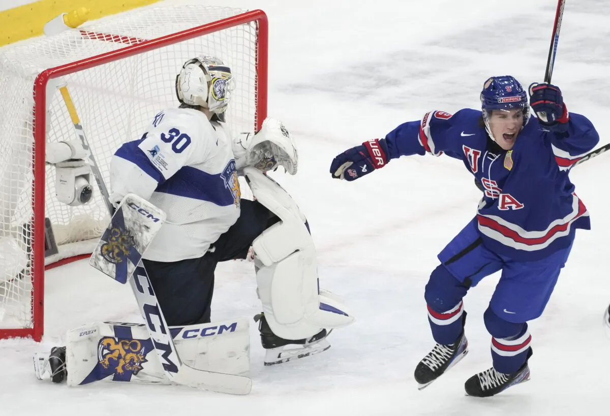 Team USA's Ryan Leonard (9) celebrates a goal by teammate Jimmy Snuggerud (not shown) in front of Finland's goaltender Niklas Kokko (30) during the second period of a semifinal hockey game at the IIHF World Junior Hockey Championship in Gothenburg, Sweden, on Jan. 4, 2024. (Christinne Muschi/The Canadian Press via AP)