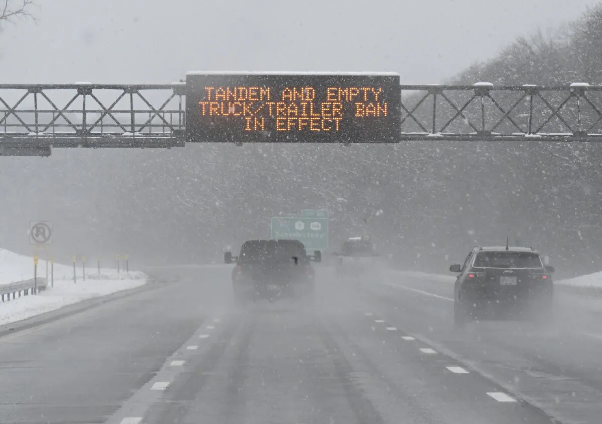 A roadway caution sign is seen on the New York Thruway as motorists commute during a winter snow storm in Albany, N.Y., on March 14, 2023. (Hans Pennink/AP Photo)