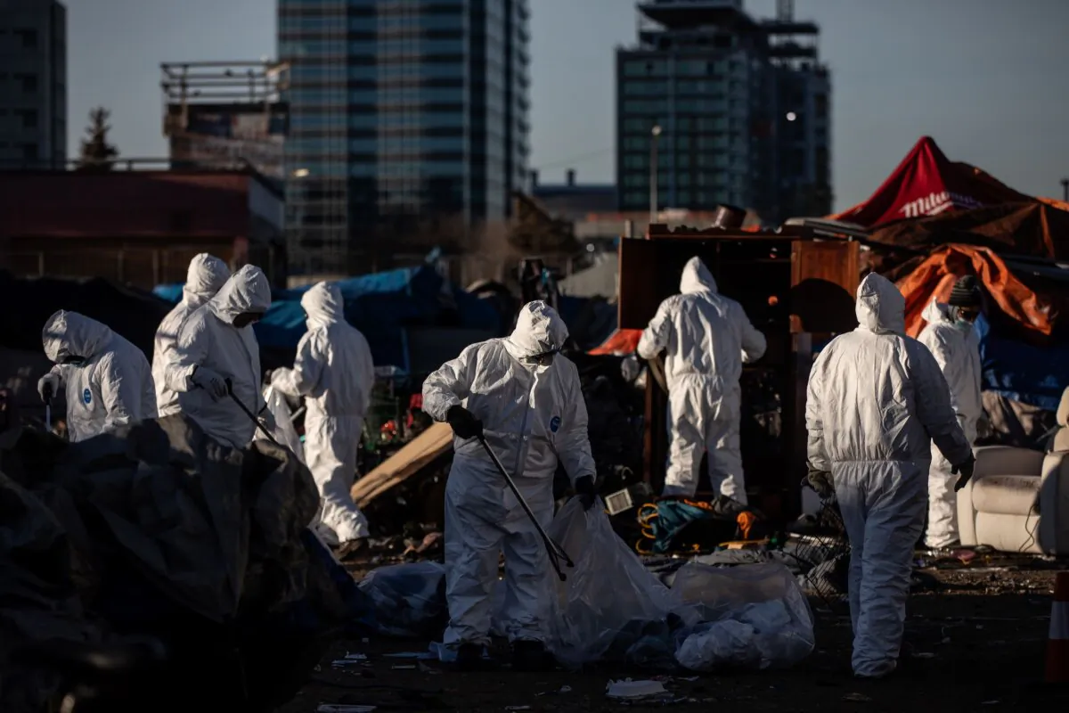 Cleanup crews tear down homeless encampments in Edmonton on Dec. 29, 2023. (The Canadian Press/Jason Franson)