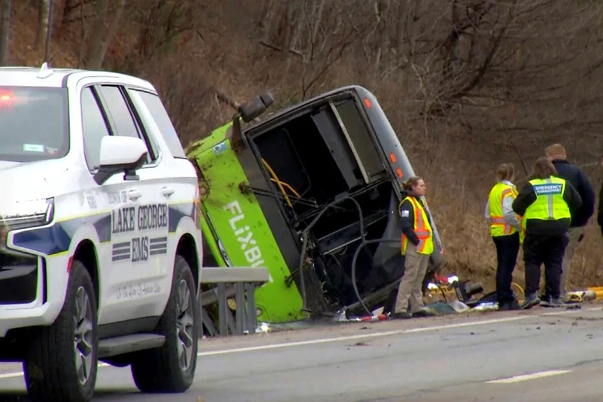 This still image from WTEN-TV video shows emergency response personnel at the site of a roll over bus accident on the Adirondack Northway, in the town of Lake George, New York on Jan. 5, 2024. (WTEN-TV via AP)