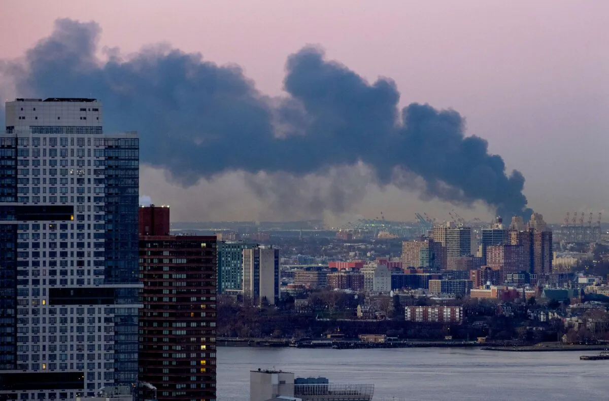 Smoke rises south of the New York borough of Manhattan as a warehouse burns in Elizabeth, N.J., spreading smoke over the southern skyline of New York on Jan. 5, 2024. (Craig Ruttle/AP Photo)