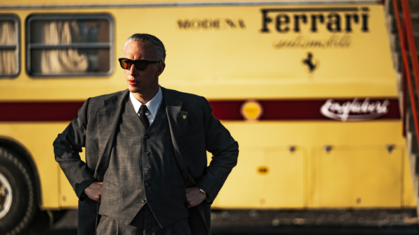 man in front of yellow bus in FERRARI