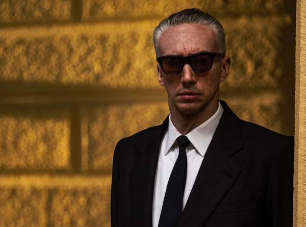 man in suit and sunglasses in FERRARI