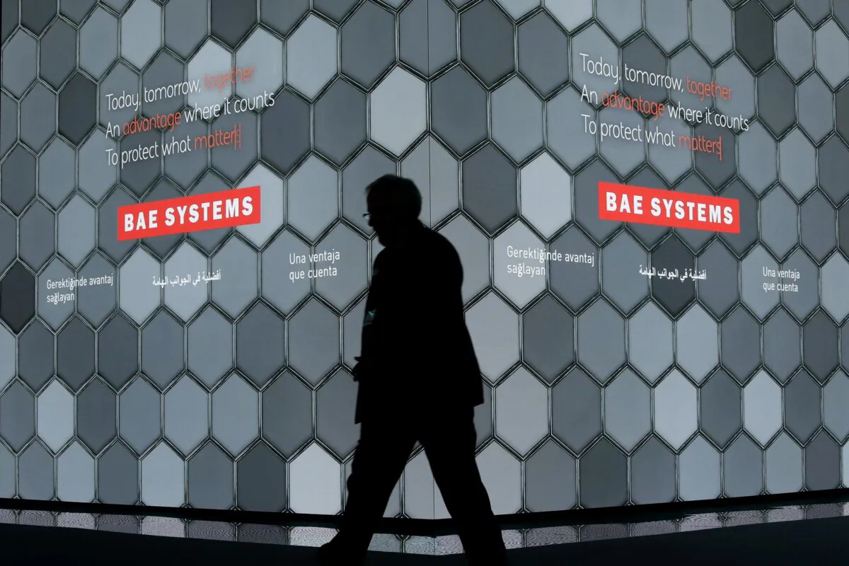 A man walks past a screen in the BAE Systems chalet at the Farnborough Airshow in Farnborough, England, on July 16, 2018. (Matt Dunham/AP Photo)
