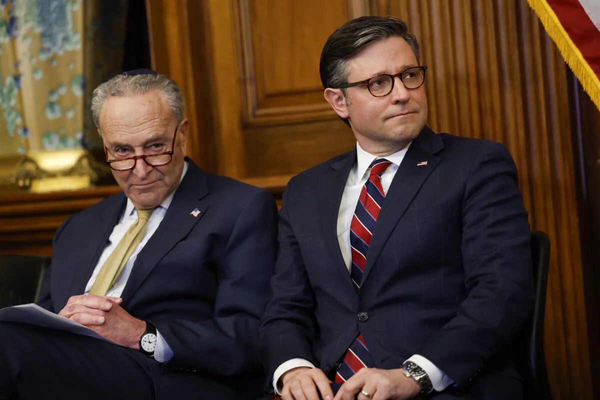Senate Majority Leader Chuck Schumer (D-N.Y.) and House Speaker Mike Johnson (R-La.) listen during remarks at a Capitol Menorah lighting ceremony at the U.S. Capitol Building in Washington on Dec. 12, 2023. (Anna Moneymaker/Getty Images)