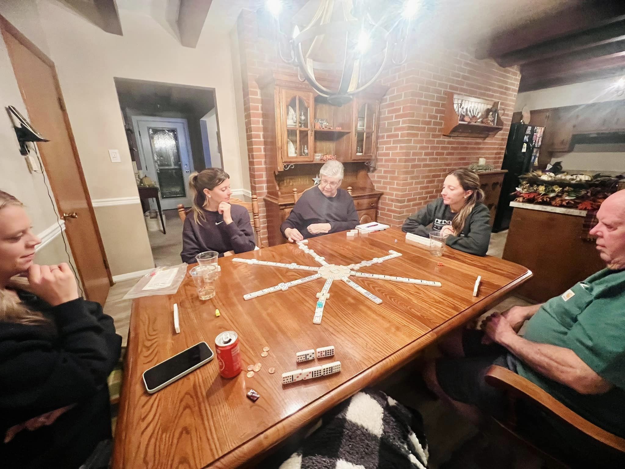 Mr. and Mrs. George playing dominoes with their grandkids.