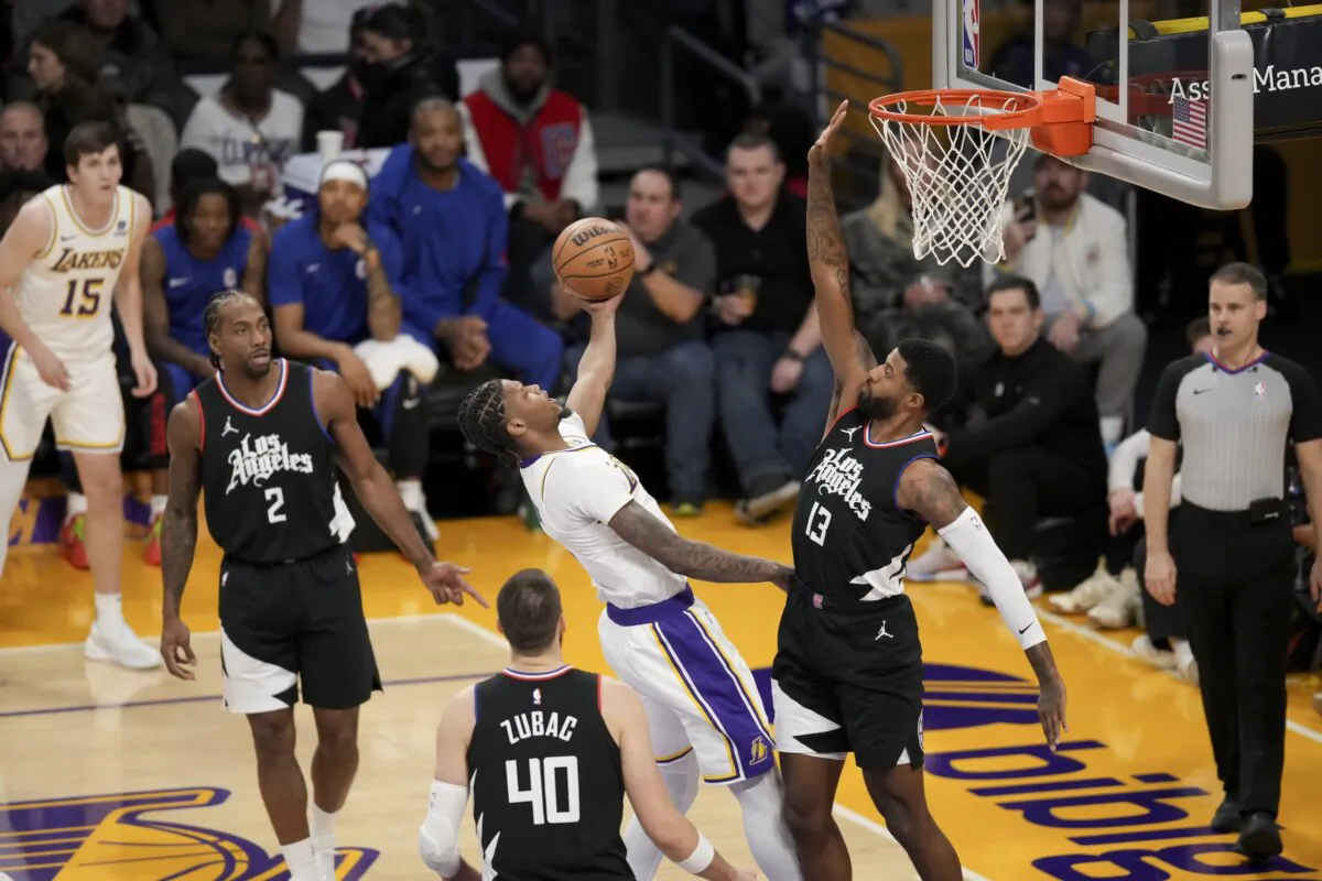Los Angeles Lakers forward Cam Reddish, center top, drives to the basket against Los Angeles Clippers forward Paul George (13) during the first half of an NBA basketball game in Los Angeles on Jan. 7, 2024. (Eric Thayer/AP Photo)