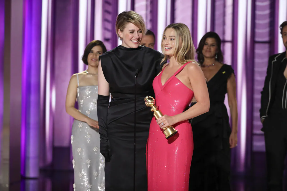This image released by CBS shows co-director Greta Gerwig (L) and actor Margot Robbie accepting the award for best cinematic and box office achievement for the film "Barbie" during the 81st Annual Golden Globe Awards in Beverly Hills, Calif., on Jan. 7, 2024. (Sonja Flemming/CBS via AP)