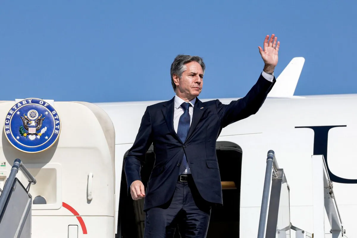 U.S. Secretary of State Antony Blinken waves as he departs from Abu Dhabi for Saudi Arabia on Jan. 8, 2024, during his week-long trip aimed at calming tensions across the Middle East. (Evelyn Hockstein/POOL/AFP via Getty Images)
