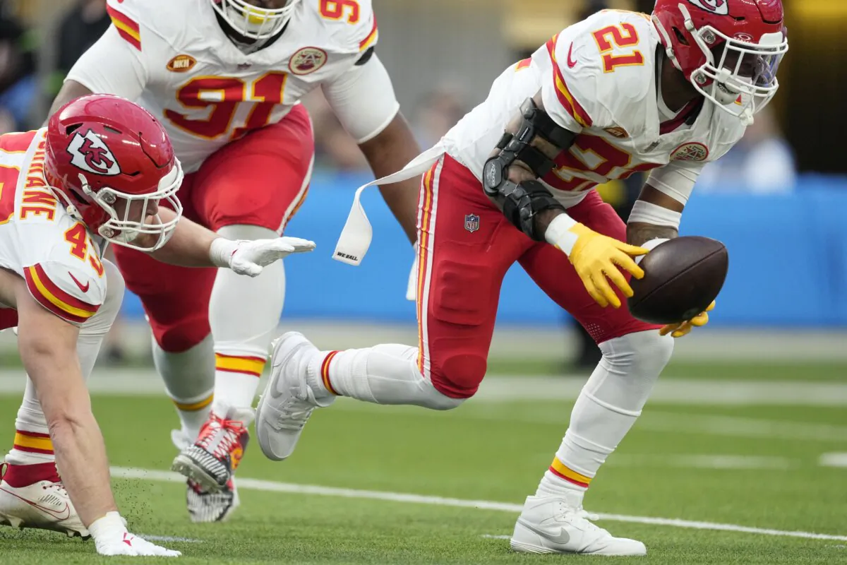 Kansas City Chiefs safety Mike Edwards (21) picks up a fumble before running it back for a touchdown during the first half of an NFL football game against the Los Angeles Chargers in Inglewood, Calif., on Jan. 7, 2024. (Ashley Landis/AP Photo)
