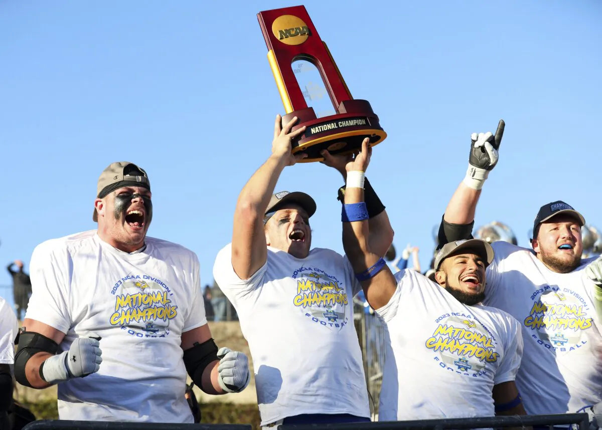 From left to right, South Dakota State's Garret Greenfield, quarterback Mark Gronowski, Jason Freeman and Mason McCormick celebrate with the trophy after their win over Montana at the FCS Championship NCAA college football game in Frisco, Texas, on Jan. 7, 2024. (Richard W. Rodriguez/AP Photo)