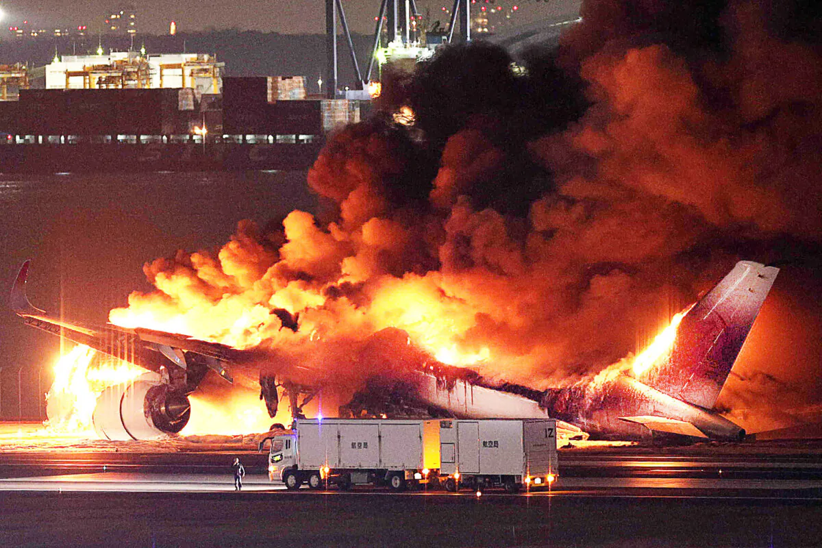 A Japan Airlines plane on fire on a runway of Tokyo's Haneda Airport on Jan. 2, 2024.(STR/Jiji Press/AFP via Getty Images)