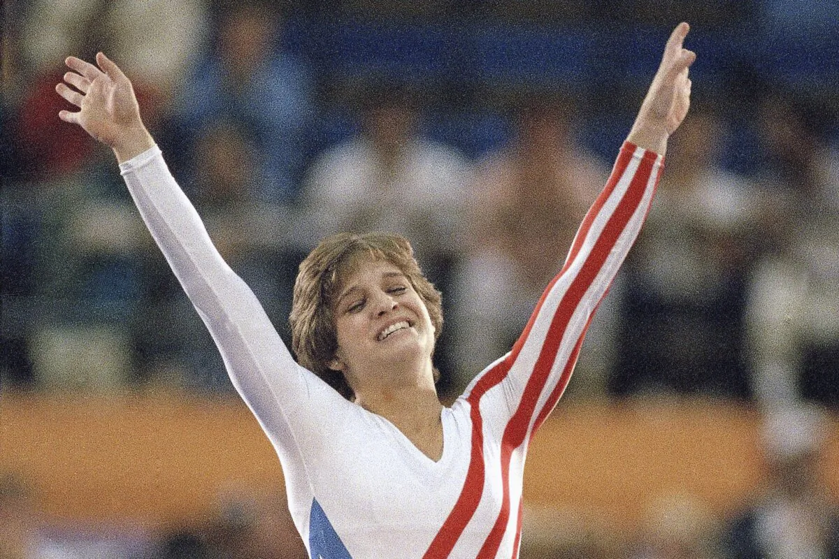 Mary Lou Retton celebrates her balance beam score at the 1984 Olympic Games in Los Angeles on Aug. 3, 1984. (Lionel Cironneau/AP Photo)