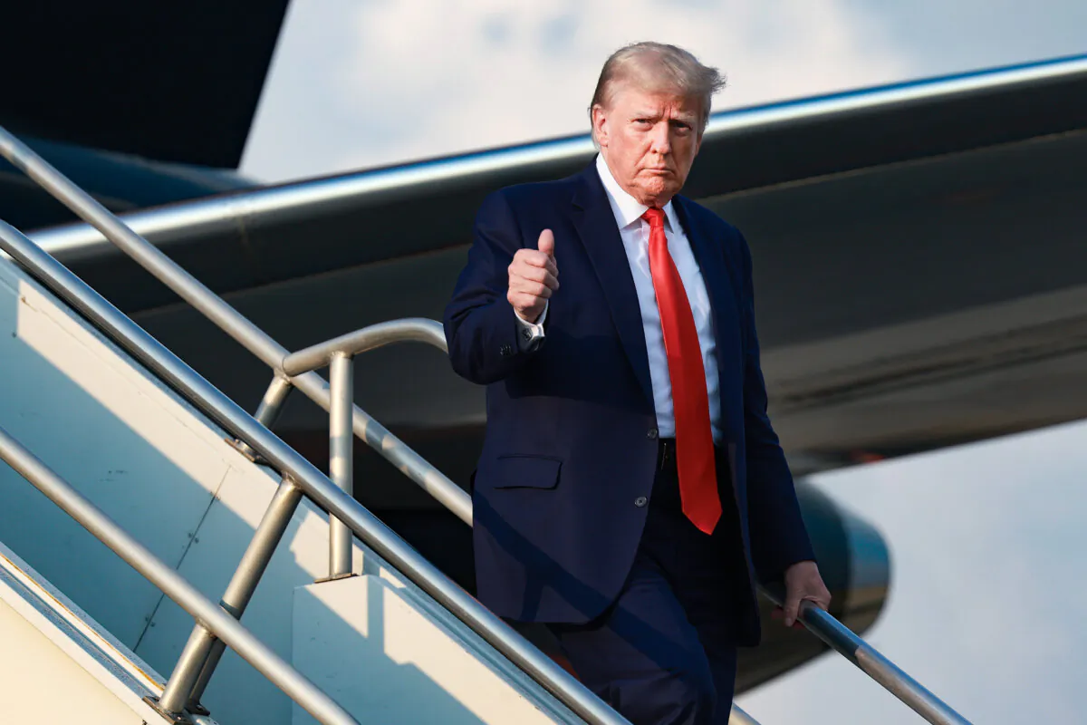 Former President Donald Trump gives a thumbs up as he arrives at Atlanta Hartsfield-Jackson International Airport, in Atlanta, on Aug. 24, 2023. (Joe Raedle/Getty Images)