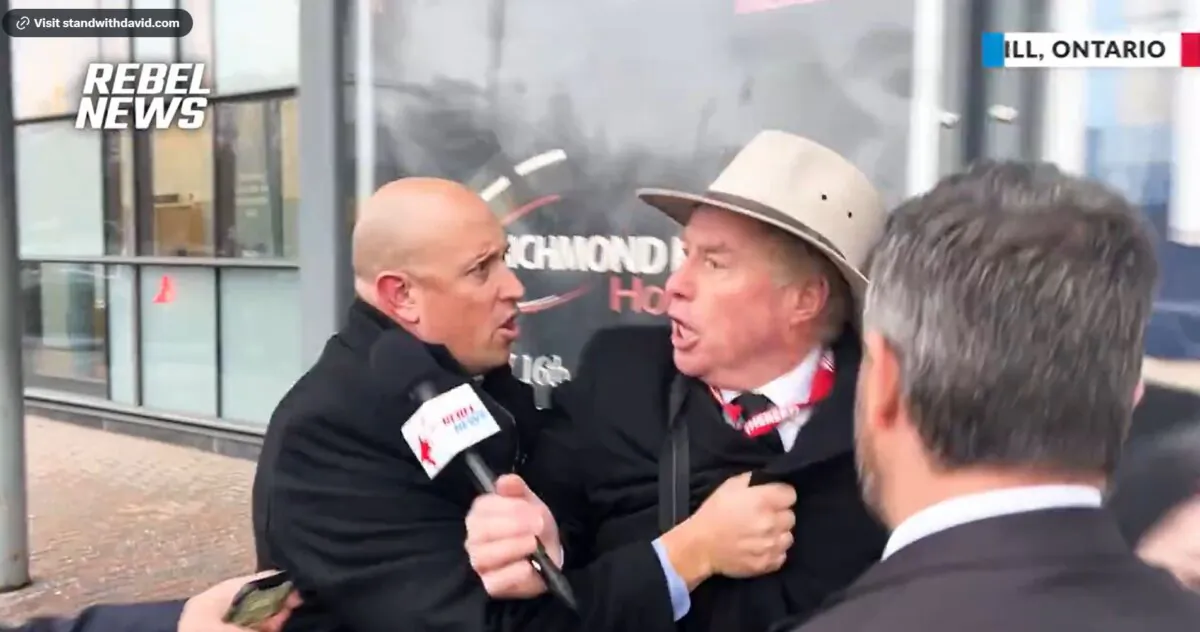 A plainclothes RCMP officer (L) grabs Rebel News reporter David Menzies, telling Mr. Menzies he is under arrest, in Richmond Hill, Ont., on Jan. 8, 2024. (Screenshot/Rebel News Video)
