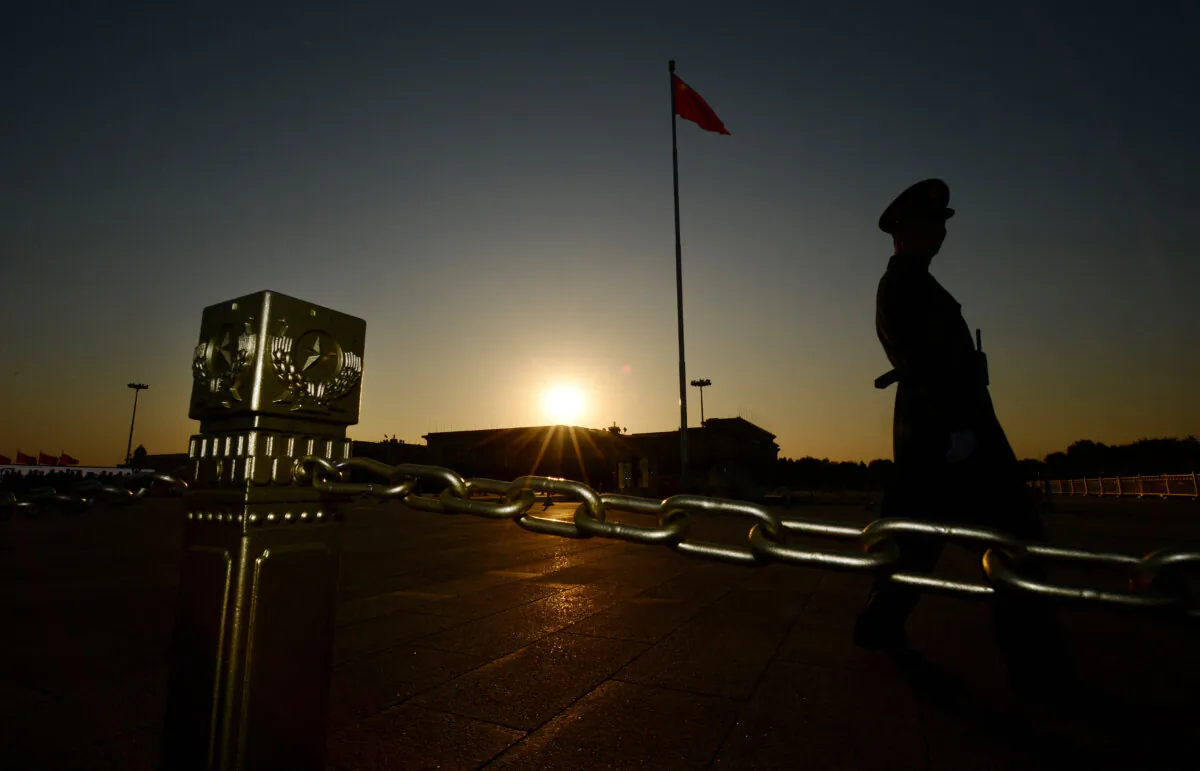 A Chinese paramilitary officer patrols Tiananmen Square in front of the Great Hall of the People in Beijing on Nov. 12, 2013. (Mark Ralston/AFP via Getty Images)