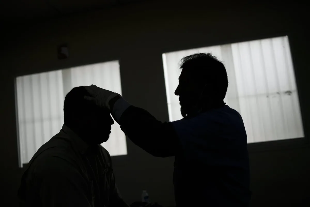 A doctor performs acupuncture therapy on a recovering COVID-19 patient at a government run health centre in the Coche neighbourhood of Caracas, Venezuela, on Feb. 25, 2021. (The Canadian Press/AP-Matias Delacroix)