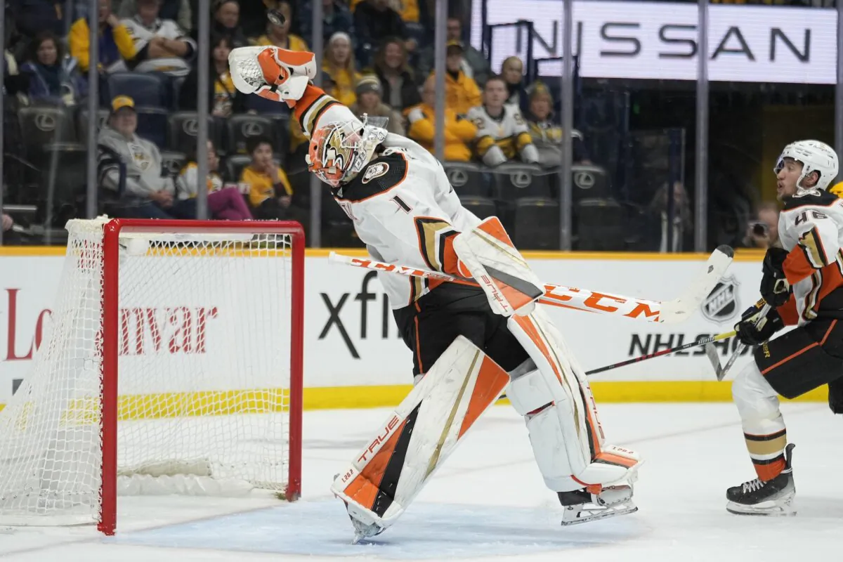 Anaheim Ducks goaltender Lukas Dostal (1) catches the puck as he defends the goal during the second period of an NHL hockey game against the Nashville Predators in Nashville, Tenn., on Jan. 9, 2024. (George Walker IV/AP Photo)