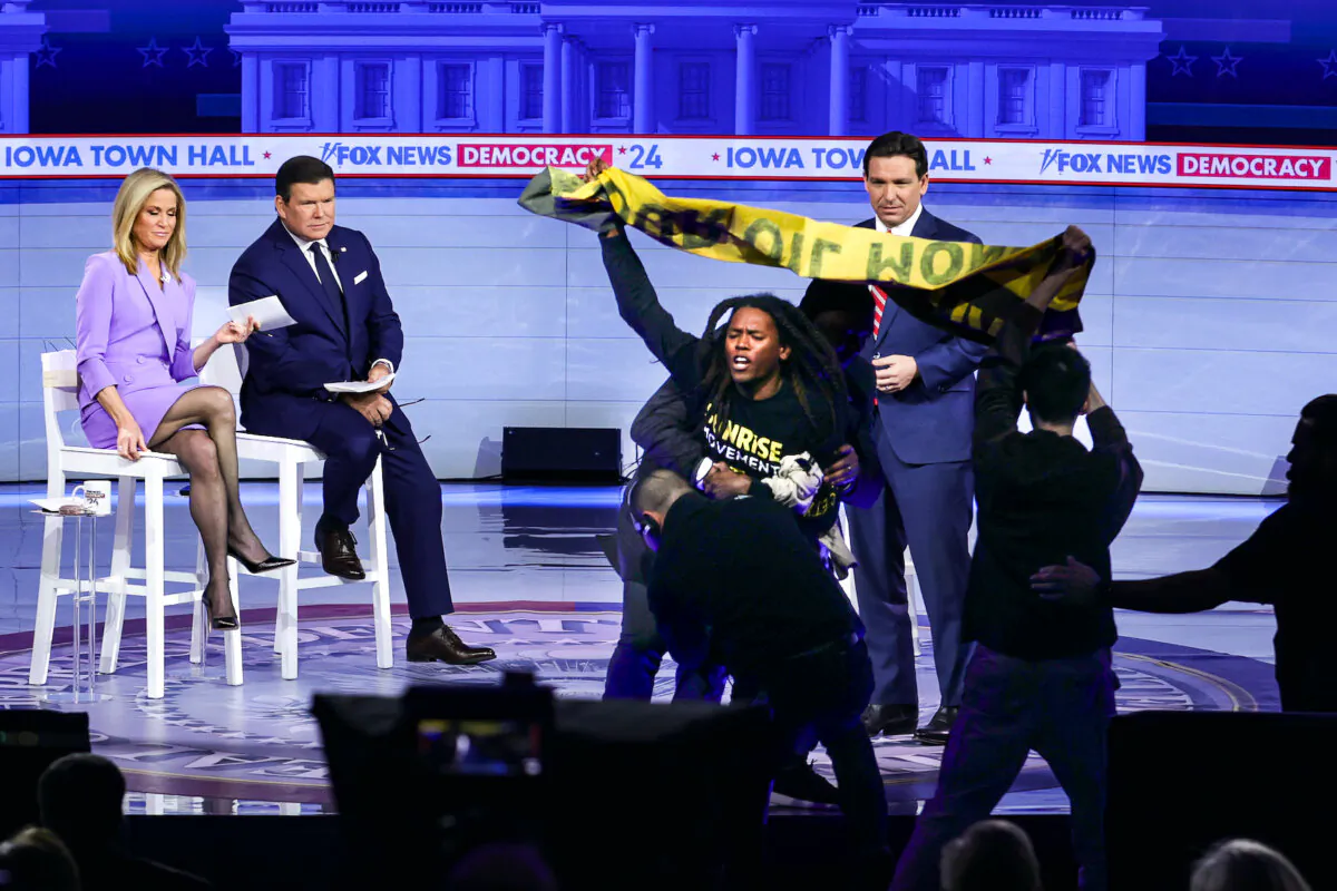 One of the protesters interrupting Republican presidential candidate Florida Gov. Ron DeSantis during a Fox News Town Hall with moderators Martha MacCallum and Bret Baier in Des Moines, Iowa on Jan. 9, 2024. (Alex Wong/Getty Images)