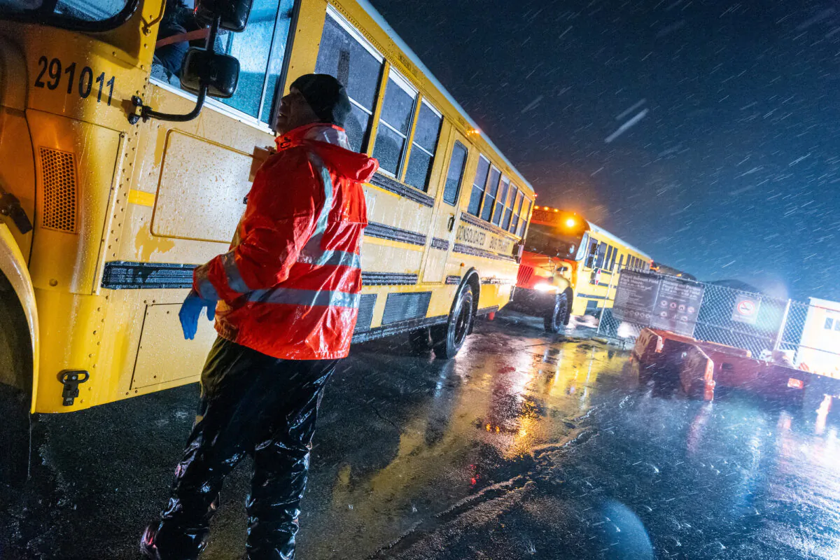 Nearly 2,000 illegal immigrants are evacuated by school buses from tents at Floyd Bennett Field to a local high school in preparation for a storm with estimated wind speeds of more than 70 mph in the Brooklyn borough of New York City on Jan. 9, 2024. (Spencer Platt/Getty Images)