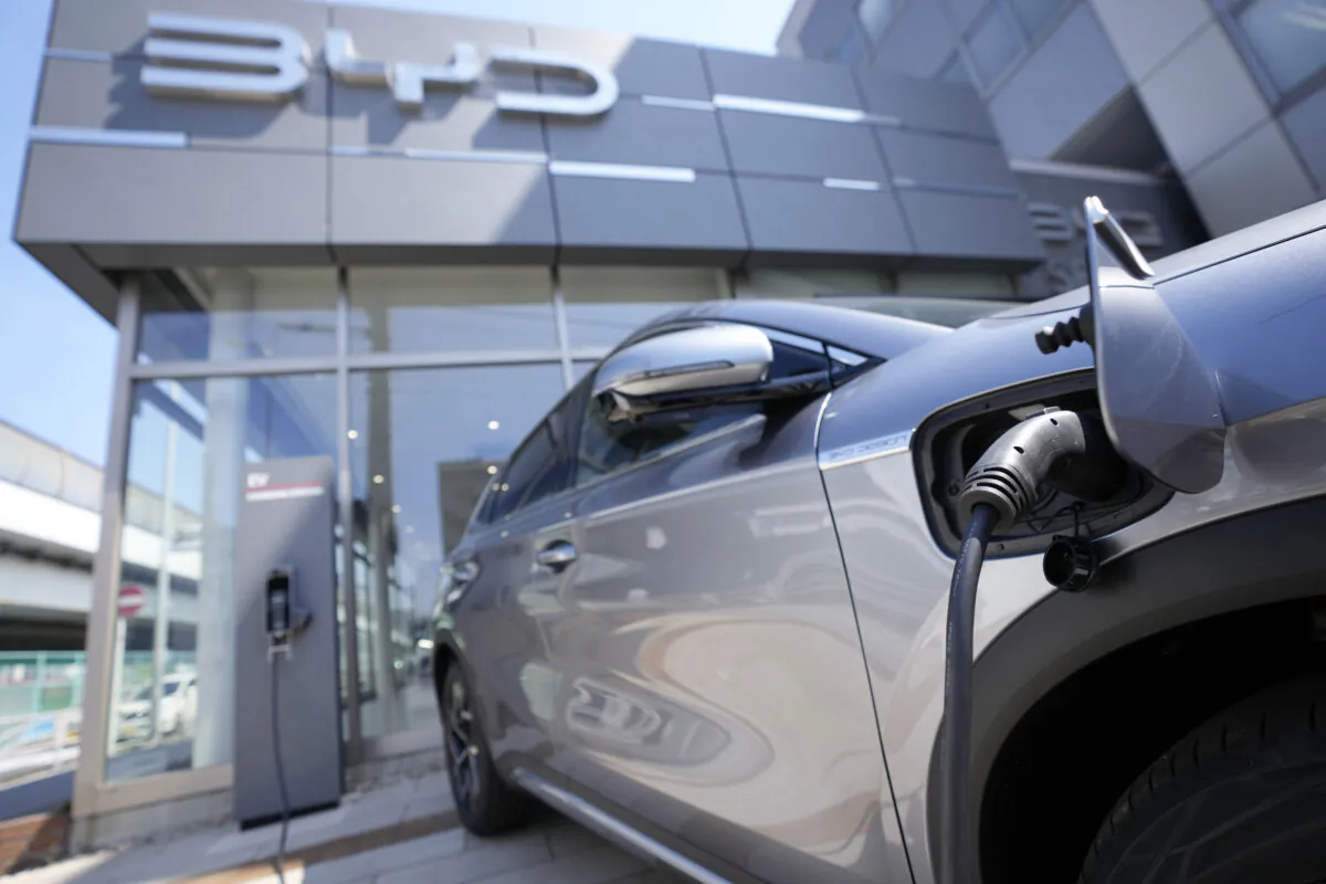 A BYD ATTO 3 electric sports utility vehicle gets charged while on display at a BYD dealership in Yokohama, Japan, on April 4, 2023. BYD is a leading Chinese electric car exporter that is starting to compete with Western and Japanese brands in their home markets. (AP Photo/Eugene Hoshiko)