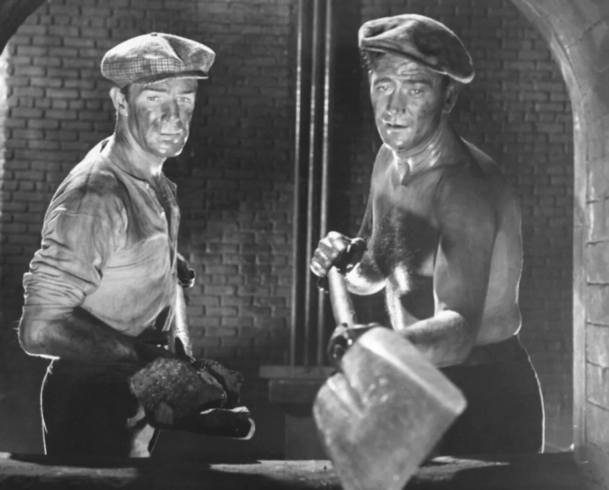 Coal miner pals Cash Evans (Randolph Scott, L) and Pittsburgh Markham (John Wayne), in “Pittsburgh.” (Universal Pictures)