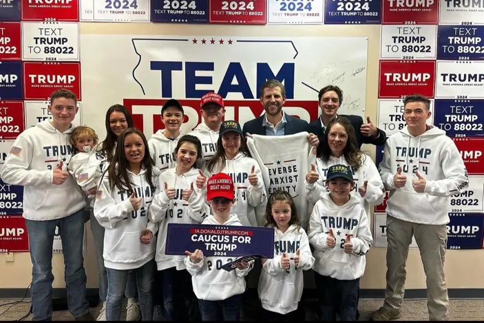 Members of the Krachenfels family of West Des Moines, Iowa, pose with Eric Trump, back row center, at a campaign headquarters for former President Donald Trump's 2024 presidential run in Urbandale, Iowa, on Jan. 4, 2024. (Courtesy of Tim Krachenfels)