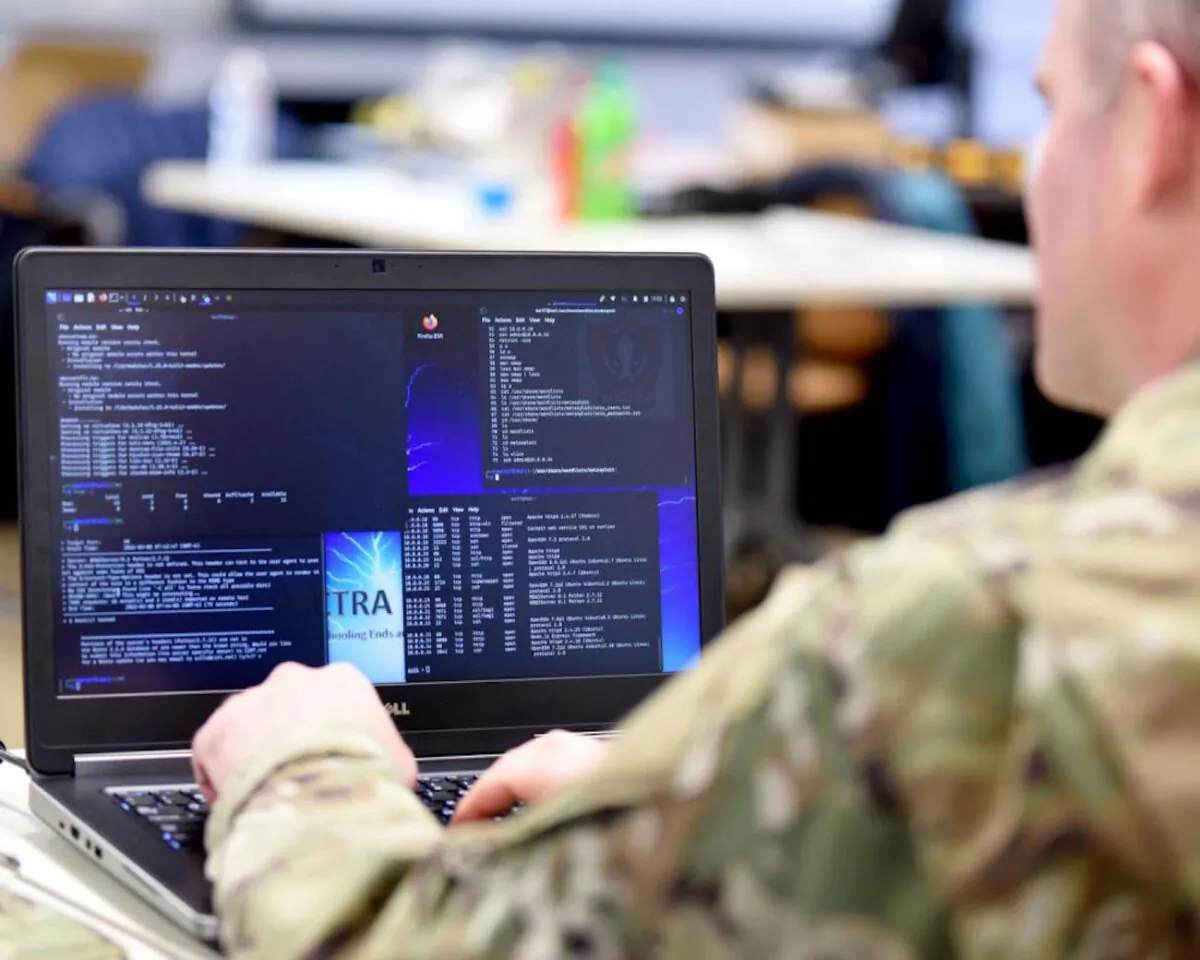U.S. Air Force Capt. Shannon Bender reviews computer information during a cyber-warfare training event in Michigan on March 8, 2022. (Master Sgt. David Eichaker/U.S. Air National Guard)