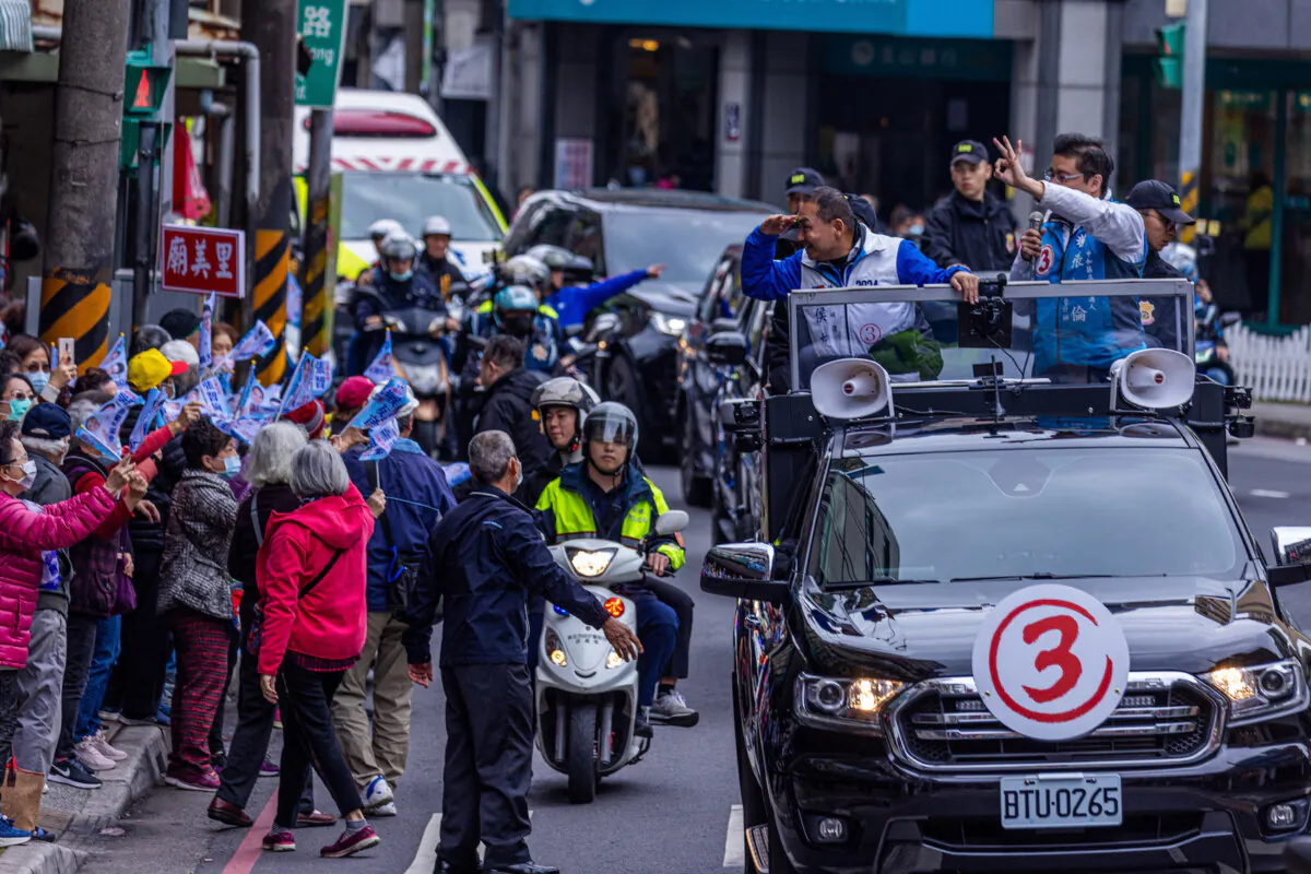 Kuomintang (KMT) presidential candidate Hou Yu-ih salutes supporters while campaigning for election in New Taipei City, Taiwan, on Jan. 4, 2024. (Annabelle Chih/Getty Images)