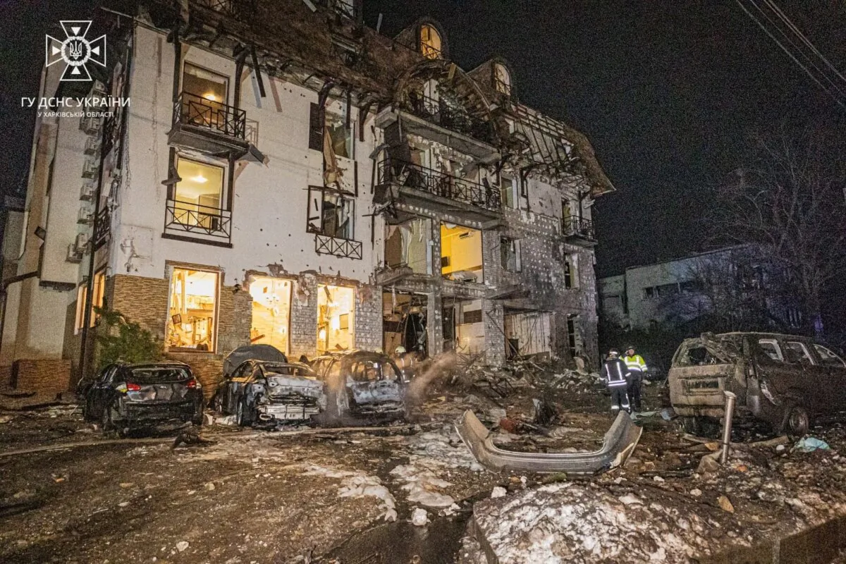 Rescuers stand at the site in the aftermath of a Russian missile strike on a hotel in Kharkiv, Ukraine, on Jan. 11, 2024. (State Emergency Service of Ukraine/Handout via Reuters)