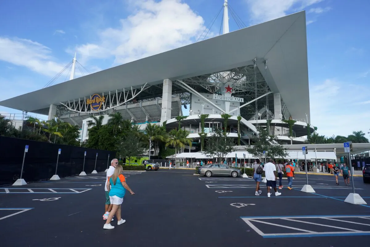 Football fans arrive at Hard Rock Stadium before a NFL preseason football game between the Miami Dolphins and the Philadelphia Eagles in Miami Gardens, Fla., on Aug. 27, 2022. (Wilfredo Lee/AP Photo)