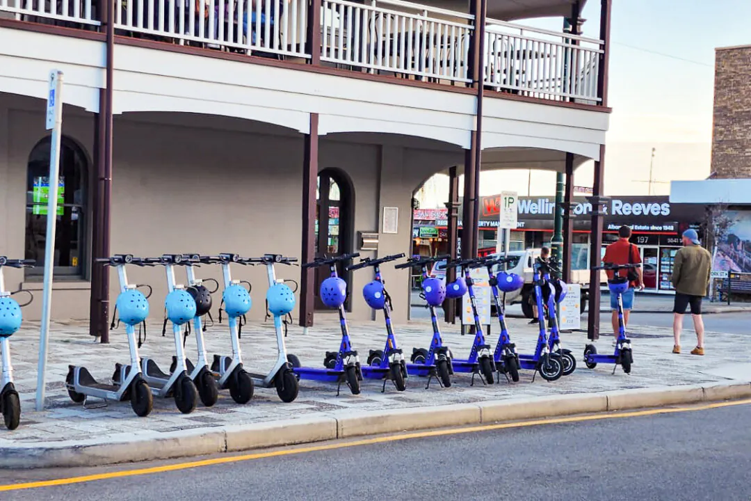 A selection of e-scooters available for hire can be seen on the corner of a street in Albany, Western Australia, on Aug. 8, 2023. (Susan Mortimer/The Epoch Times)