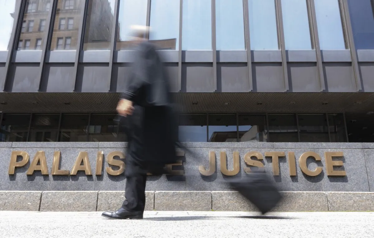 A lawyer walks past the courthouse in Montreal, on July 12, 2023. (The Canadian Press/Christinne Muschi)