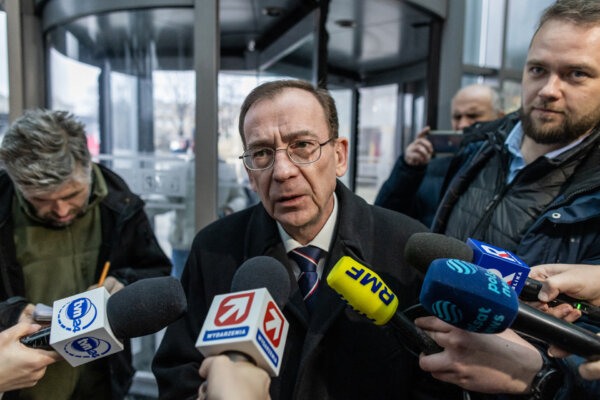 Mariusz Kaminski (C), former Polish Minister of Internal Affairs in the PiS government and former head of the Central Anticorruption Bureau, is seen as he enters the headquarters of Polish Public TV in Warsaw, on December 20, 2023. (Wojtek Radwanski //AFP via Getty Images)