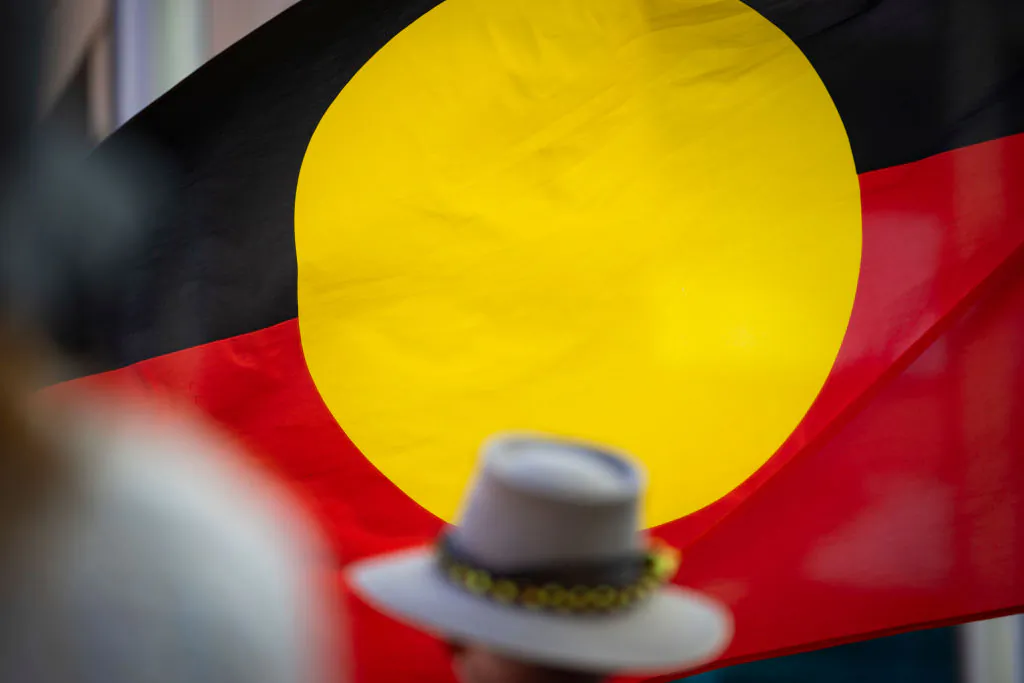 An Aboriginal flag is seen through the crowd at the "Stop Black Deaths In Custody" march in Perth, Australia on Oct. 7, 2023. (Matt Jelonek/Getty Images)